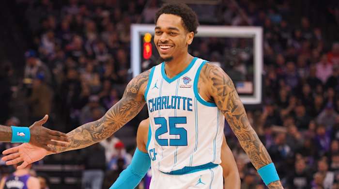 Charlotte Hornets forward P.J. Washington high fives teammates after making a basket against the Sacramento Kings during the first quarter at Golden 1 Center in Sacramento on Jan. 2, 2024.